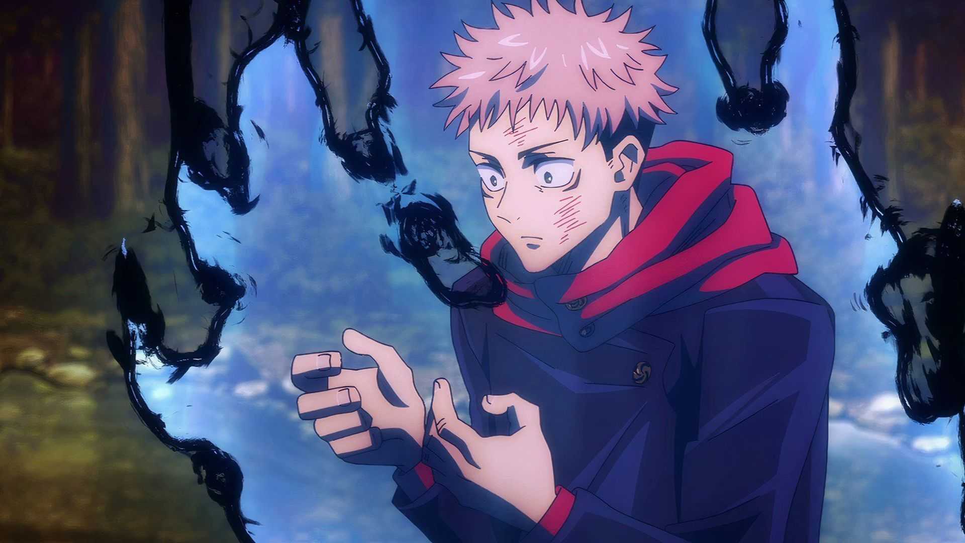Yuji Itadori regarde ses mains dans Jujutsu Kaisen alors qu'une énergie maudite éclate autour de lui.