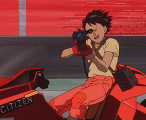 Tetsuo filming something on Kaneda's bike in Akira