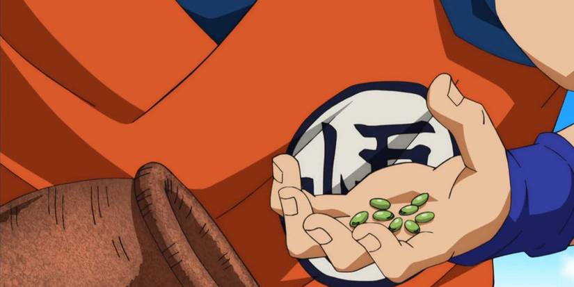 Goku grabs a handful of Senzu Beans in Dragon Ball Super.