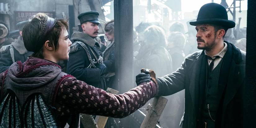 Cara Delevingne and Orlando Bloom grab hands on Carnival Row