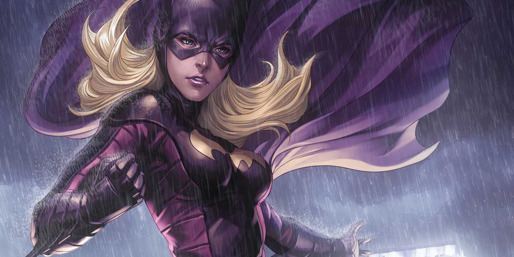 Stephine Brown wears the Batgirl costume as her cape flaps in the rain.