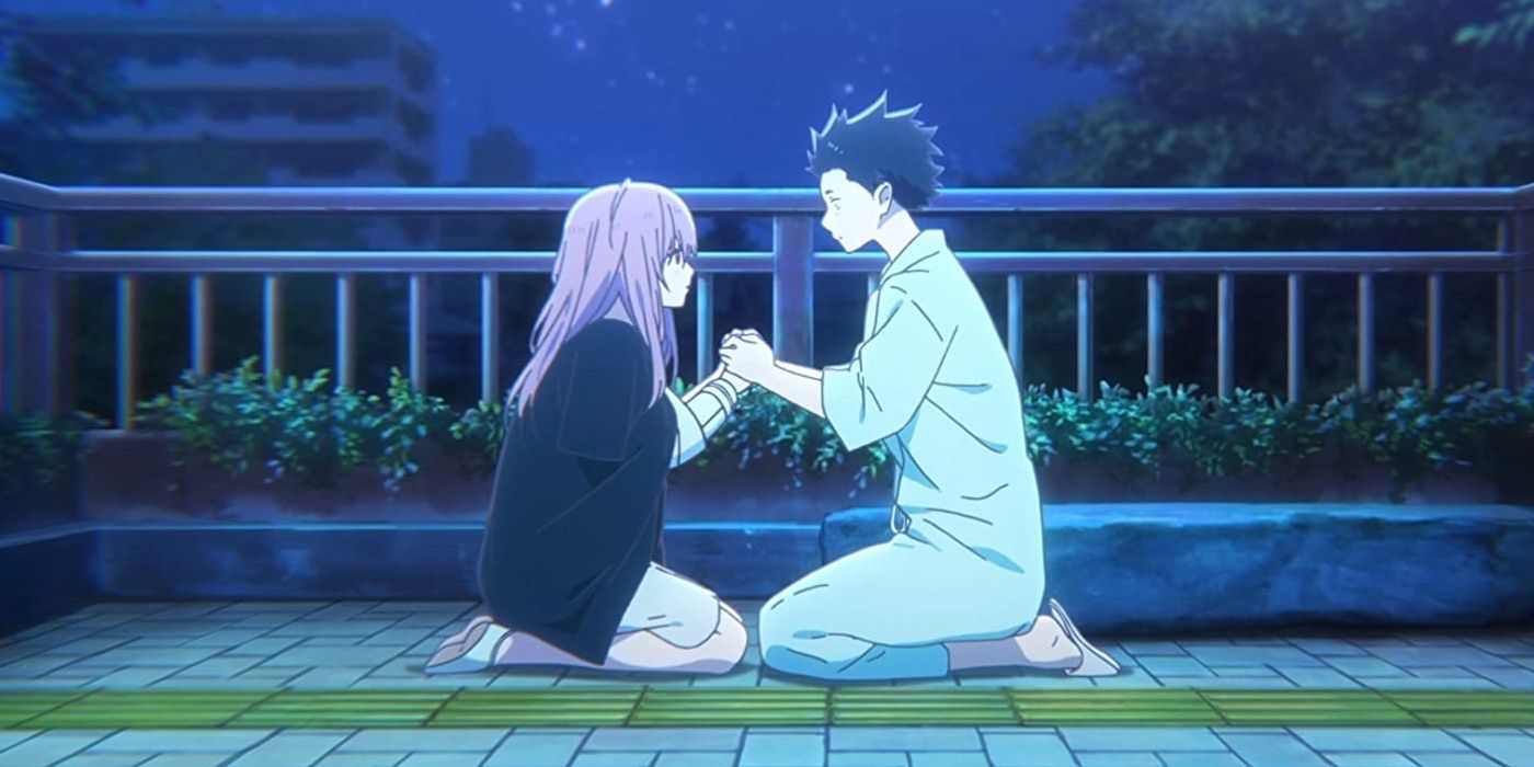 Shoko and Shoya holding hands on a balcony at night in A Silent Voice
