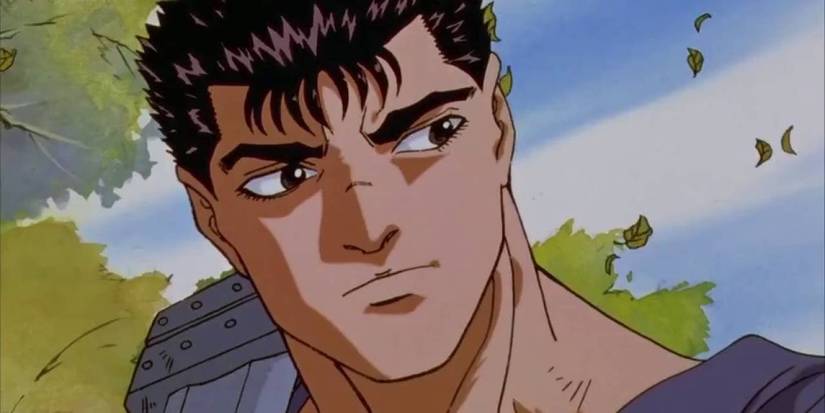 Guts looks wary in the 90s Berserk anime with trees in the background.