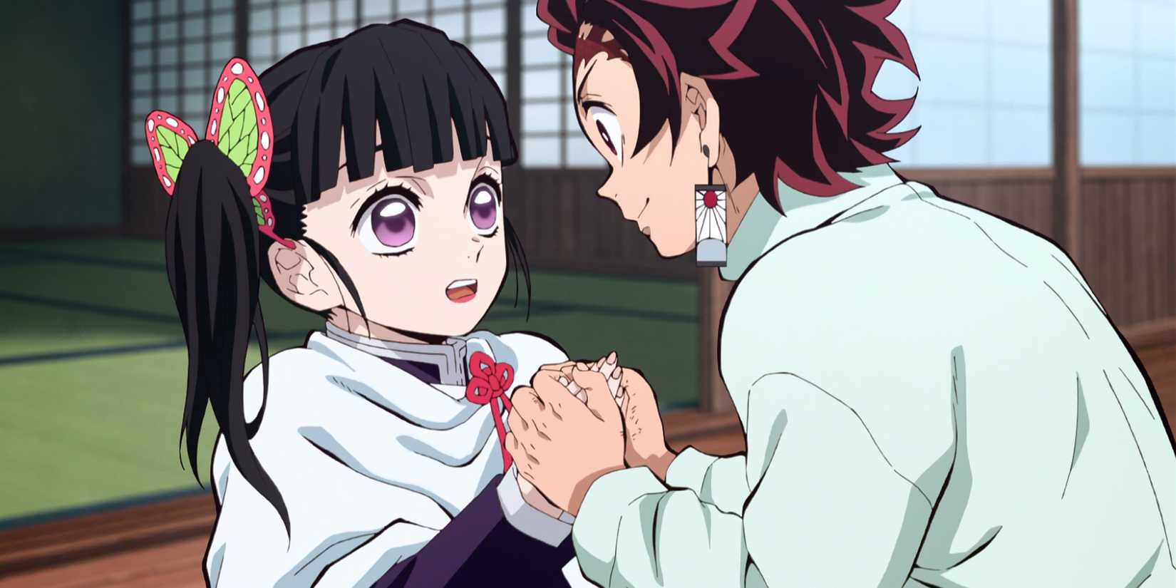 Tanjiro Kamado holds hands with Kanao Tsuyuri in an episode of the Demon Slayer anime series.