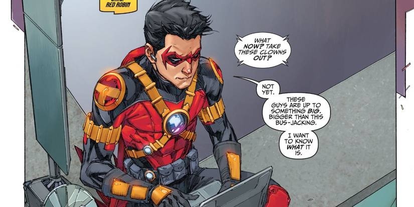 New 52 Tim Drake dressed as Red Robin sits with his laptop as he investigates something.