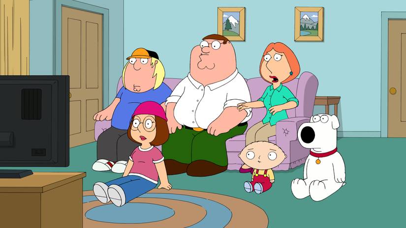 The Griffin Family watch TV in their living room whilst looking surprised. 