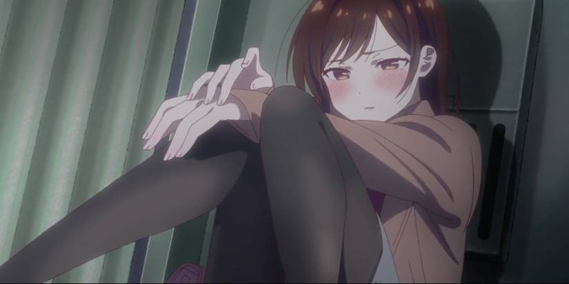 An upset Chizuru sitting against the wall after Kazuya rescinds his confession.