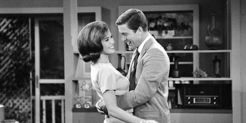 Mary Tyler Moore and Dick Van Dyke hug in The Dick Van Dyke Show.