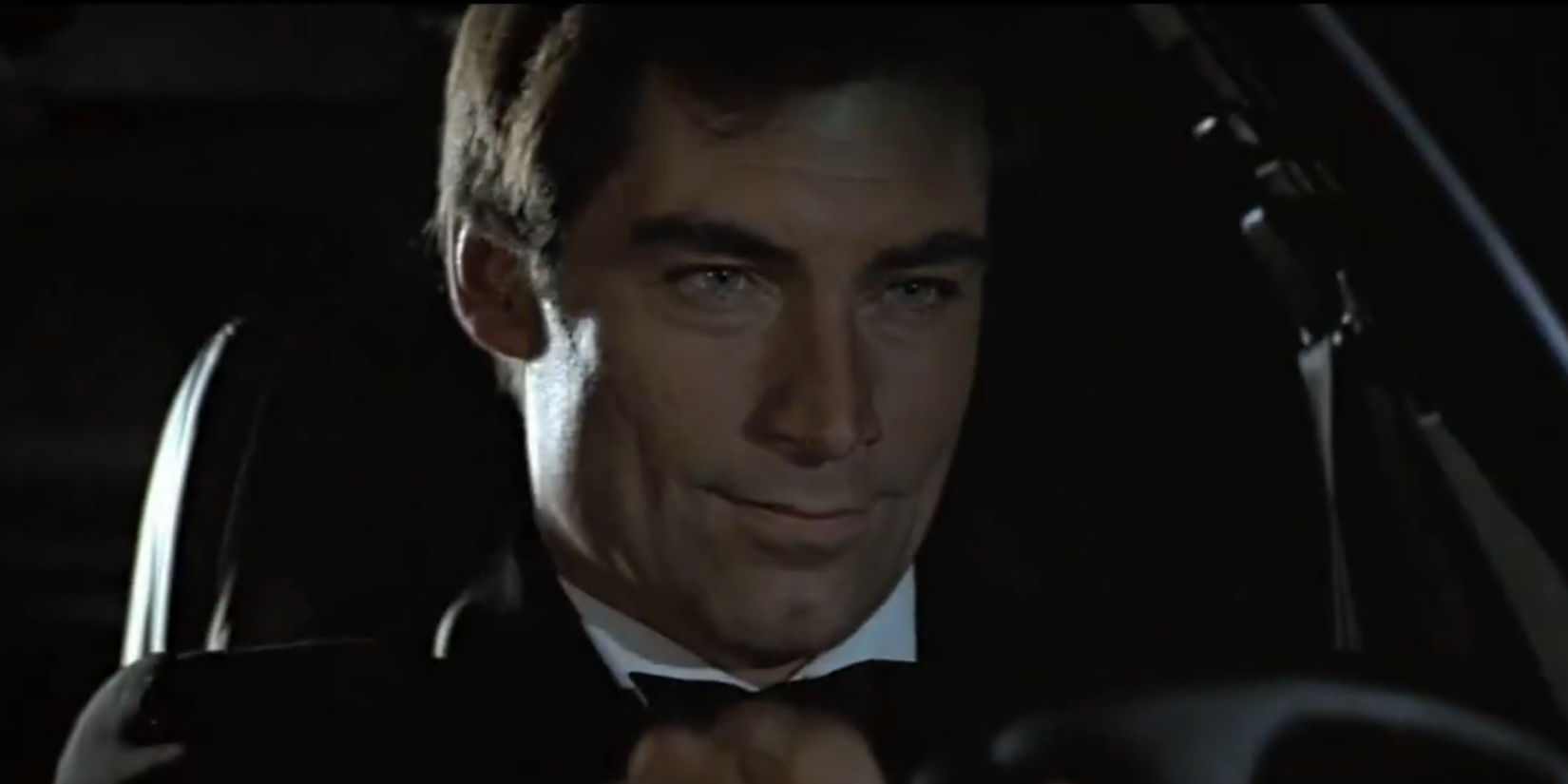 Timothy Dalton as James Bond driving a car