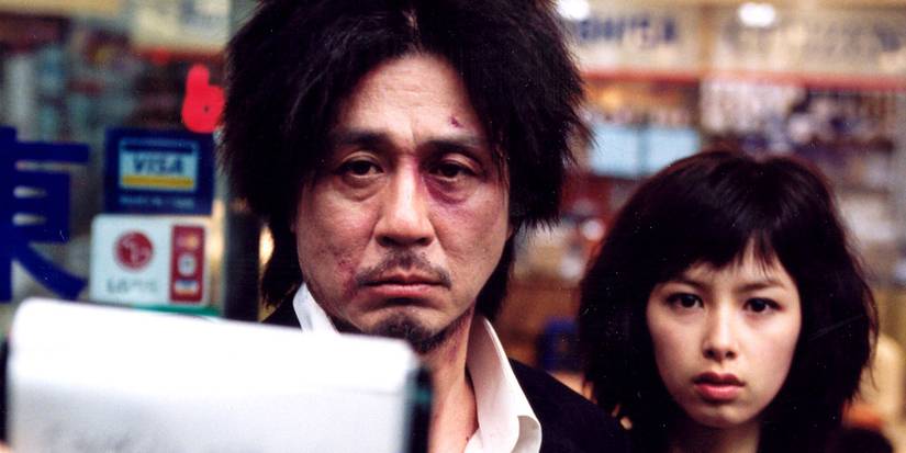 Dae-su Oh and Mi-do stare directly into camera in Oldboy.