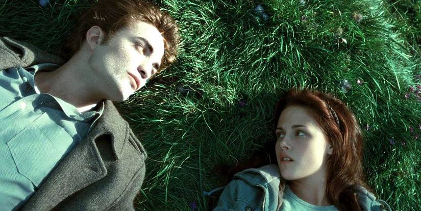 Edward and Bella lay on the grass in Twilight.