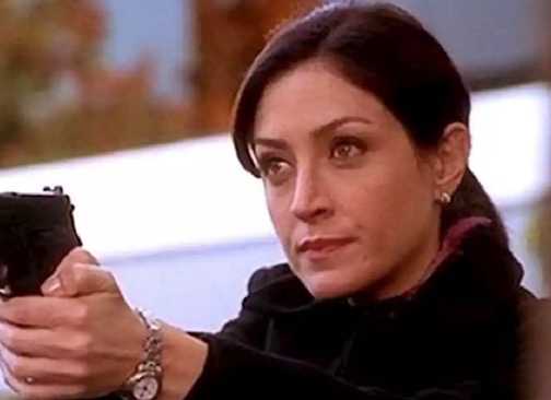 Sasha Alexander as Caitlin Todd in NCIS points her gun.
