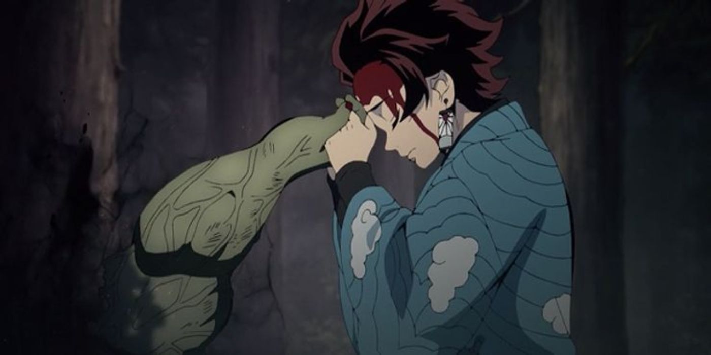 Tanjiro holds the The Hand Demon''s hand in Demon Slayer.