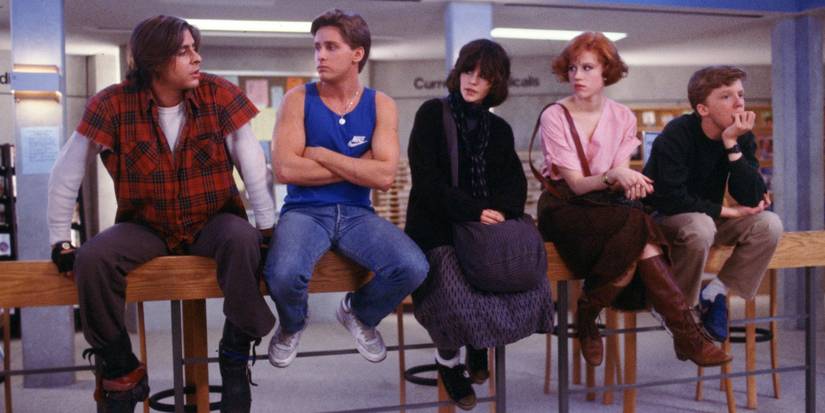 The Breakfast Club members sitting on a railing.