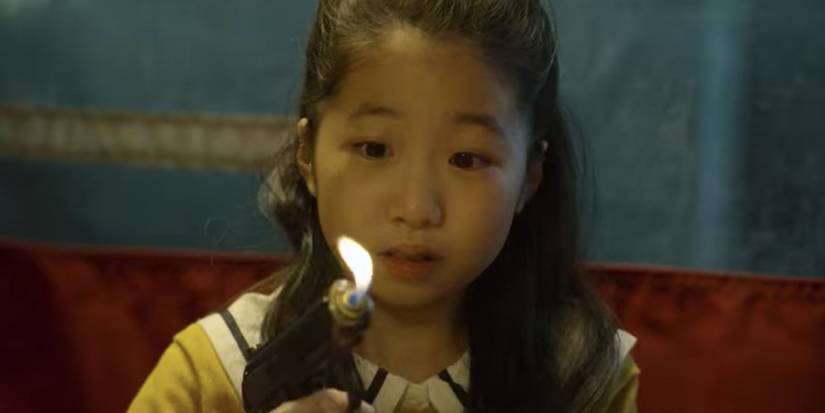 Gi-hun's daughter looking at the worst birthday gift ever in Squid Game