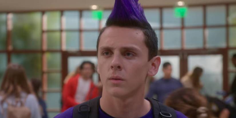 Hawk standing in a school hallway in the Cobra Kai TV series