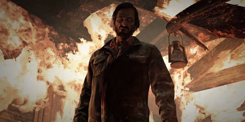 The Last of Us Part 1's David standing in front of fire.