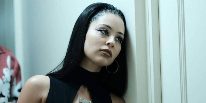 Maddy Perez from Euphoria standing outside of a bathroom.