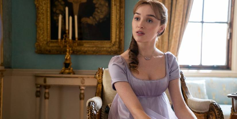 Daphne Bridgerton Sits on a Chair Wearing a Purple Dress