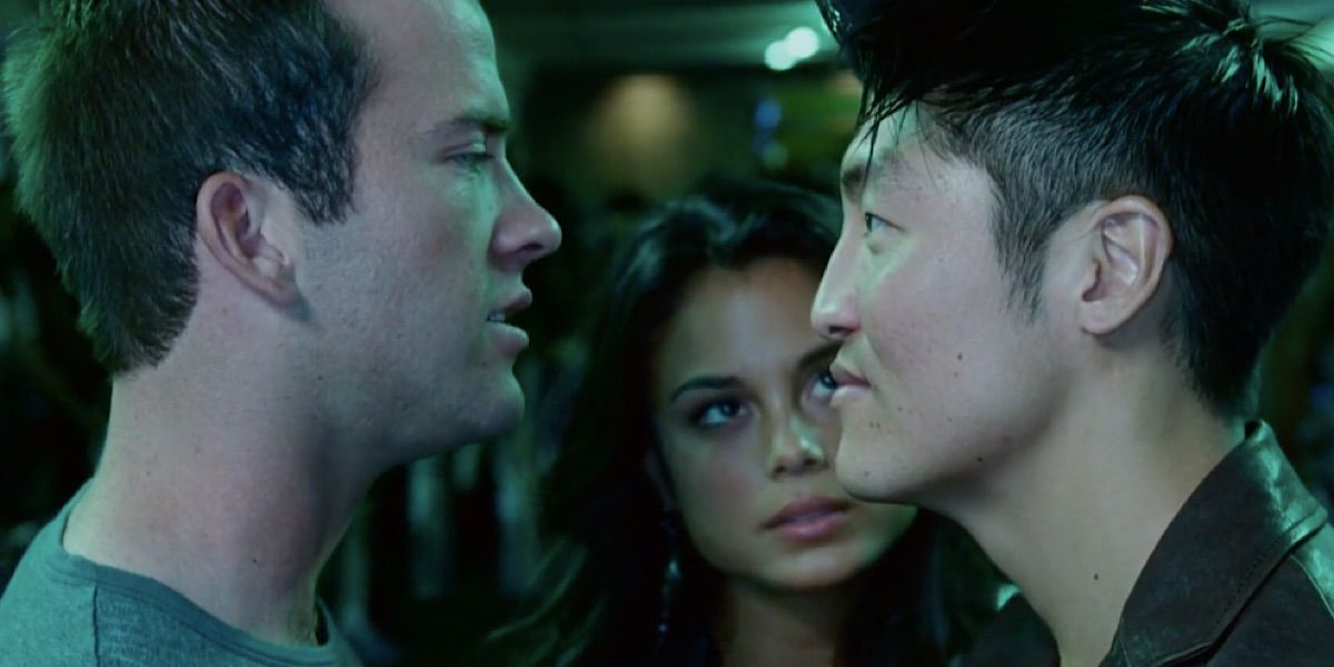 Sean Boswell staring at D.K. in Tokyo Drift with Neela standing between them