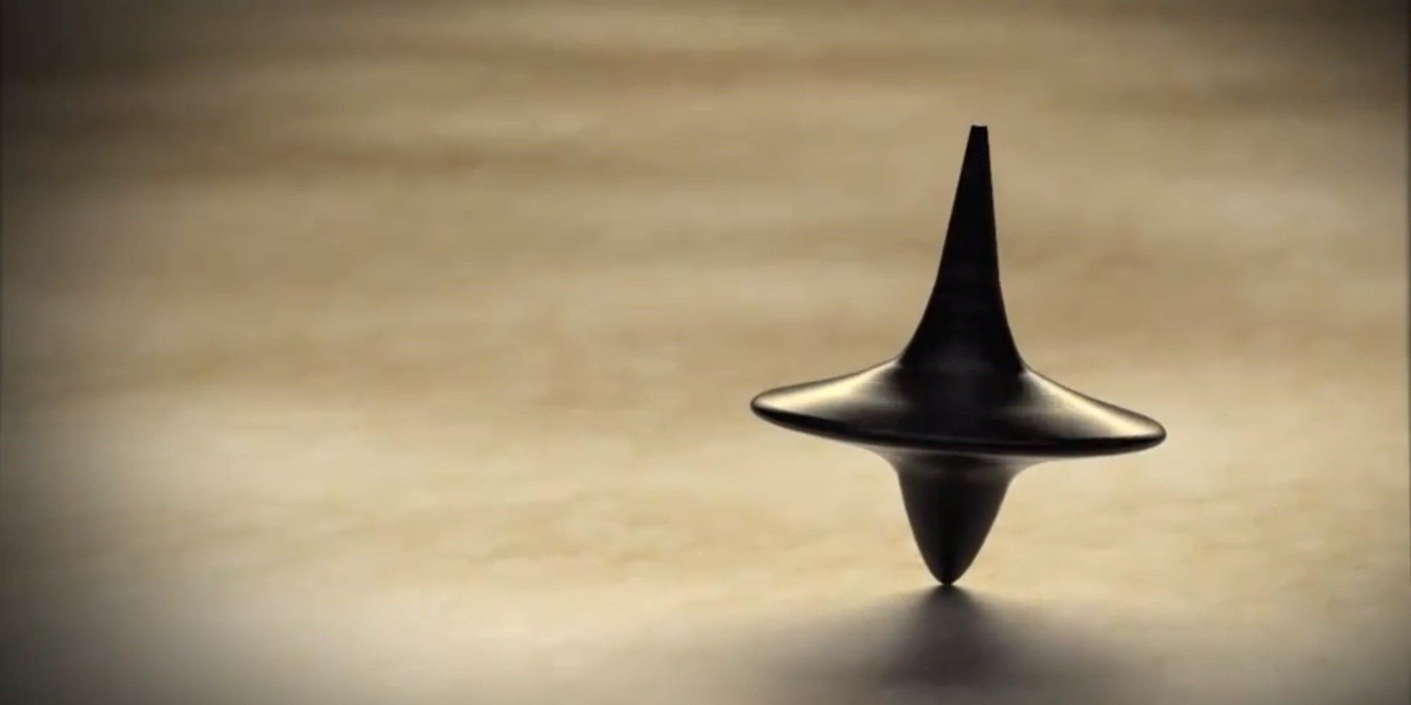 Inception, directed by Christopher Nolan, image features the spinning top totem
