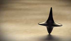 Inception, directed by Christopher Nolan, image features the spinning top totem