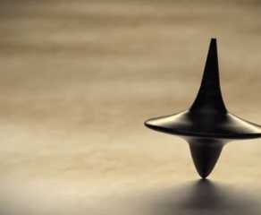 Inception, directed by Christopher Nolan, image features the spinning top totem