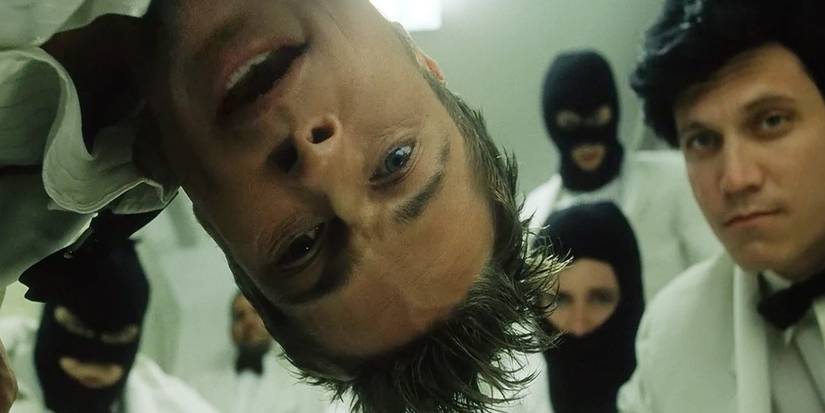 Project Mayhem threatens a rich man in Fight Club.