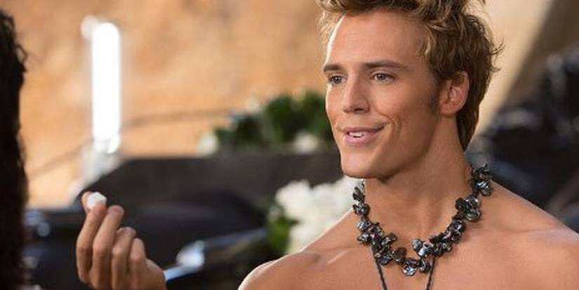 Finnick Odair (Sam Claflin) teases Katniss Everdeen with a sugar cube in The Hunger Games: Catching Fire