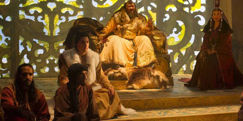 Benedict Wong's Kublai Khan sits in his throne room surrounded by his subjects in Netflix's Marco Polo.