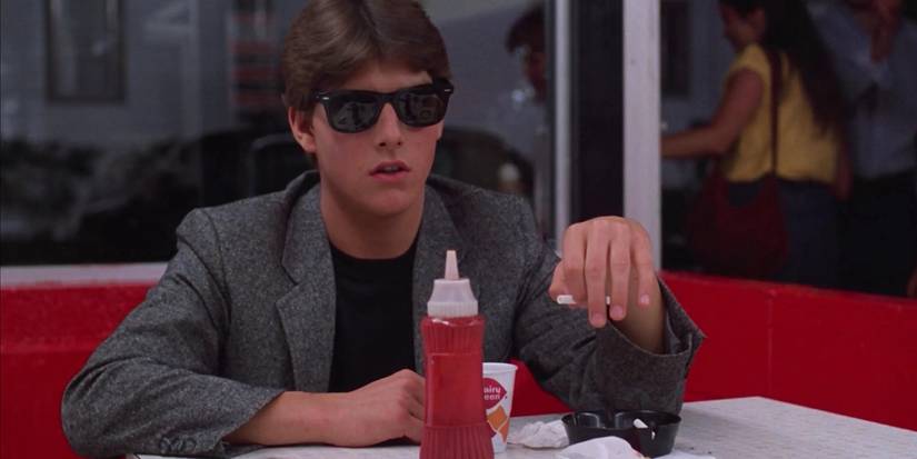 Tom Cruise as Joel Goodsen In Risky Business (1983) sitting in a diner.