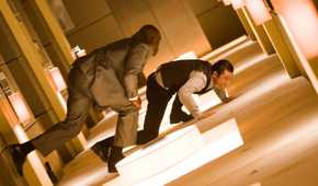 Arthur fighting a projection in the rotating hallway in Inception