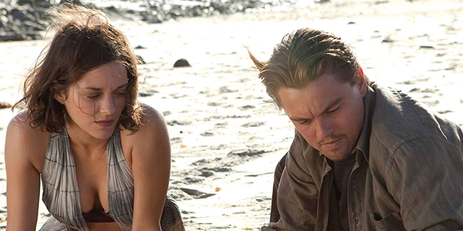 Mal and Dom Cobb sit on a beach in Inception