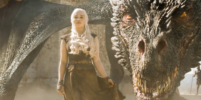 Game of Thrones Emilia Clark as Daenerys Targaryen stands beside dragon Drogon
