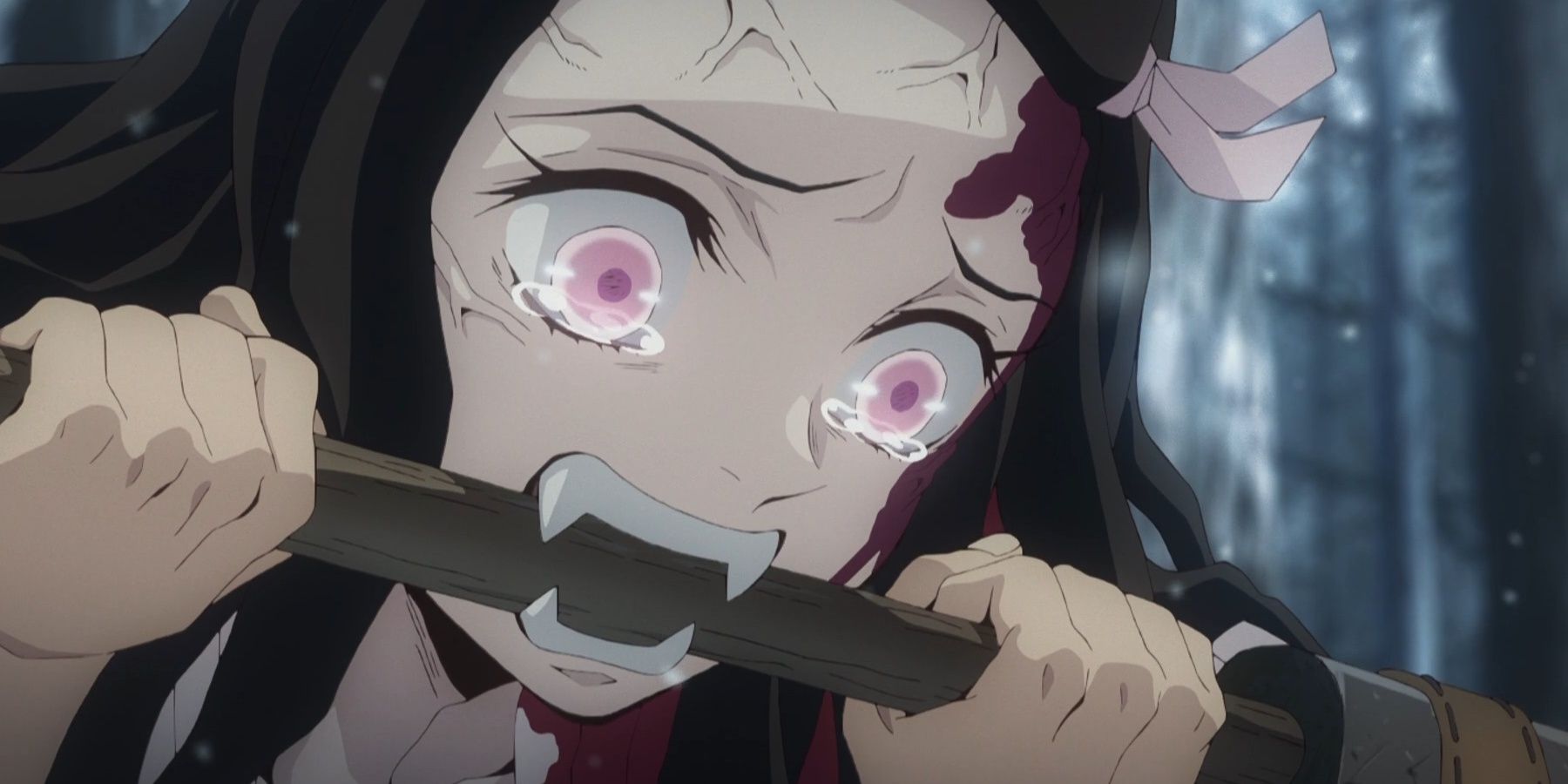 Nezuko is crying as Tanjiro restrains her fangs in Demon Slayer.