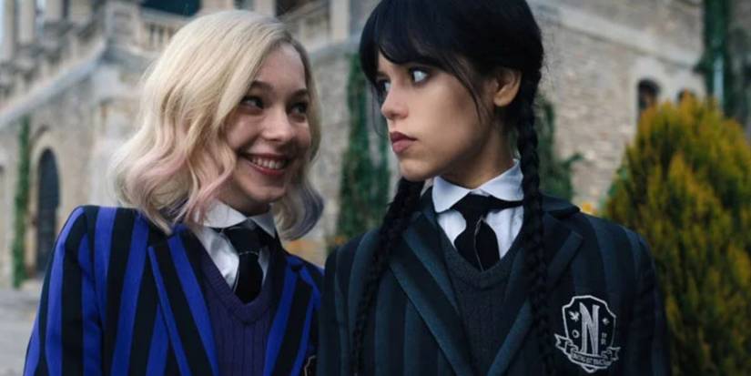Enid and Wednesday looking at each other
