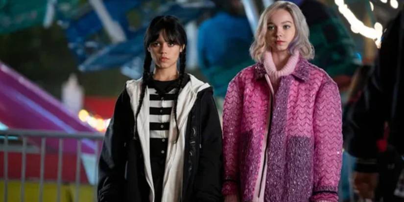 Wednesday dressed in black and Enid dressed all in pink