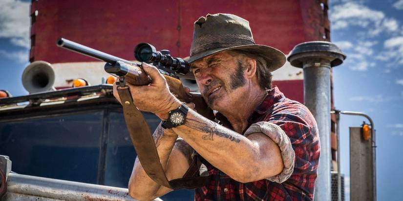Mick Taylor aims his rifle in the movie Wolf Creek