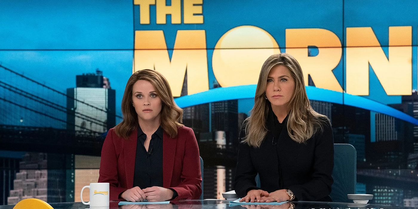 Reese Witherspoon and Jennifer Aniston behind the news desk on the series The Morning Show.
