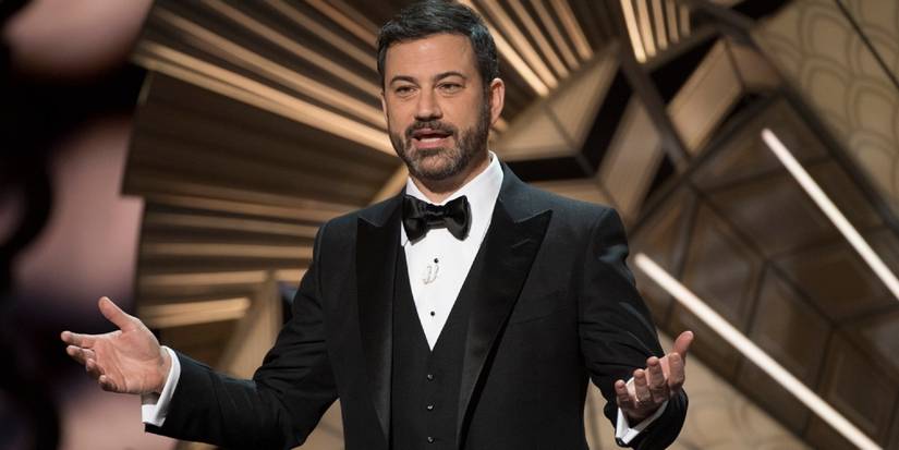 Jimmy Kimmel wearing a tuxedo and standing on the Oscars stage