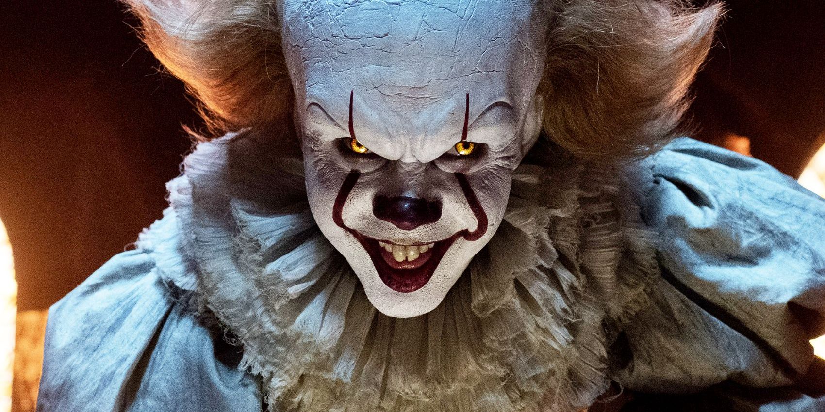 Pennywise smiling intensely in It.