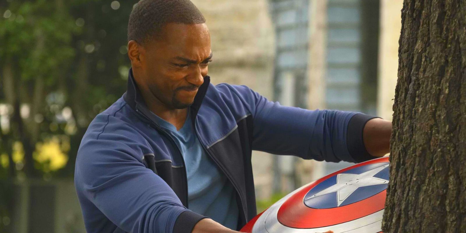 Sam Wilson struggles to pull Captain America's shield out of a tree