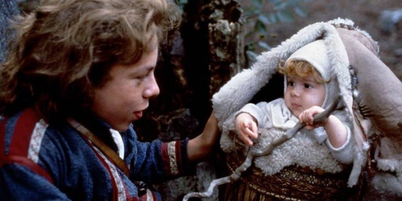 Willow looks at a baby in a Willow basket