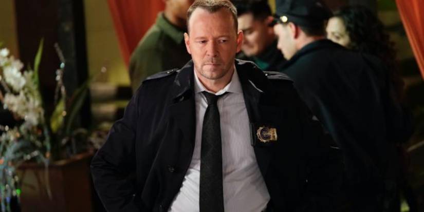 Danny Reagan (Donnie Wahlberg) looks upset in a hotel lobby in Blue Bloods.
