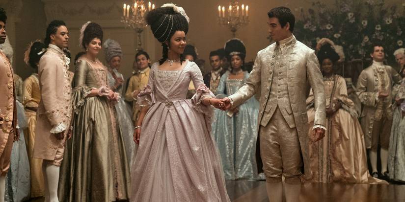 Queen Charlotte and King George look at each other before dancing at a Bridgerton ball