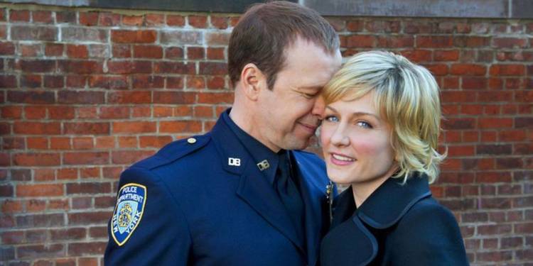 Blue Bloods' Danny Reagan leans against Linda Reagan while she looks into the camera.