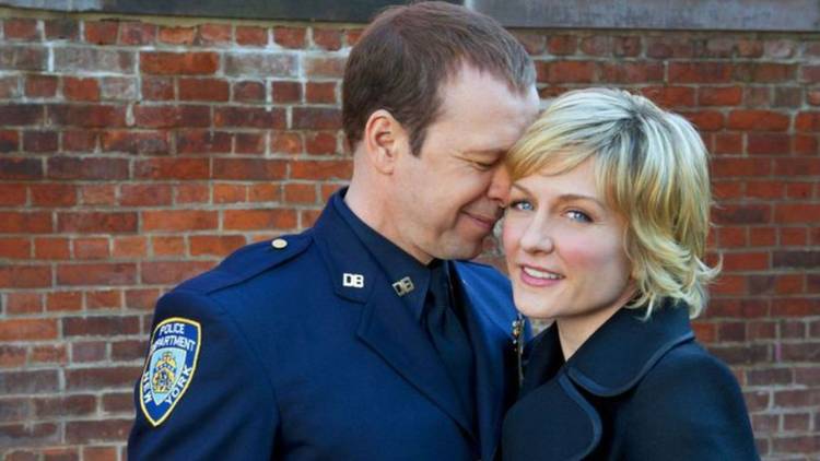 Blue Bloods' Danny Reagan leans against Linda Reagan while she looks into the camera.