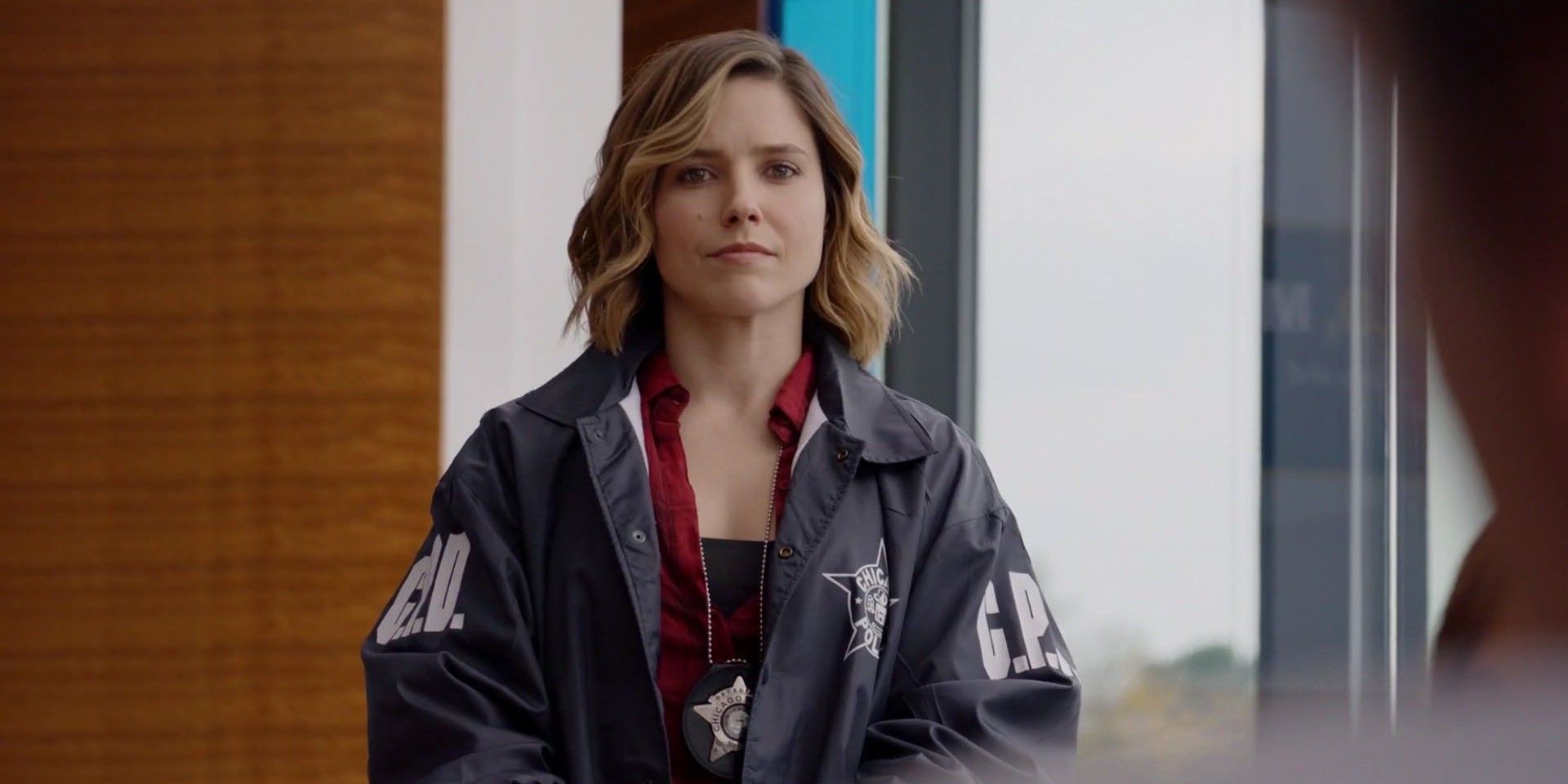 Erin Lindsay (Sophia Bush) looks at the audience in her police jacket in Chicago PD