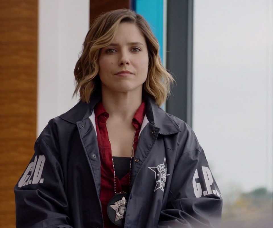 Erin Lindsay (Sophia Bush) looks at the audience in her police jacket in Chicago PD