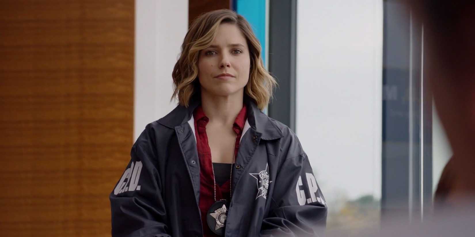 Erin Lindsay (Sophia Bush) looks at the audience in her police jacket in Chicago PD